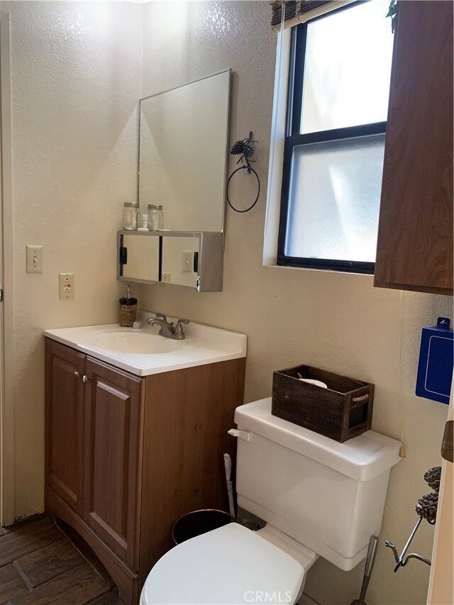 33492 Wild Rose Dr, Green Valley Lake, CA 92341 - bathroom featuring toilet, a textured wall, wood finished floors, and vanity