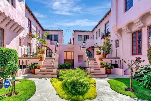 exterior space featuring stairway and stucco siding