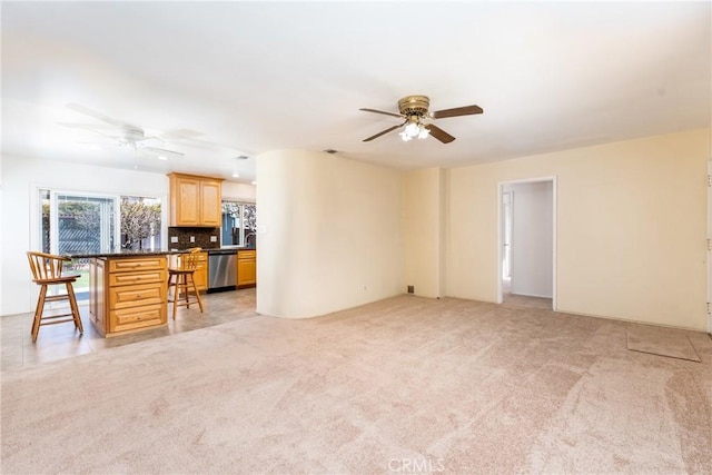 living room with ceiling fan and light colored carpet