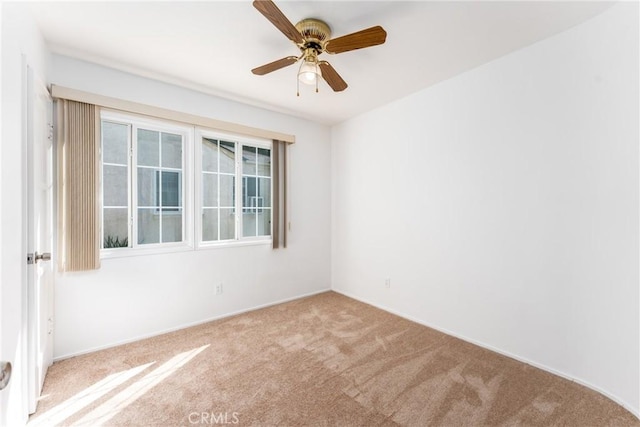 spare room with a ceiling fan and carpet flooring