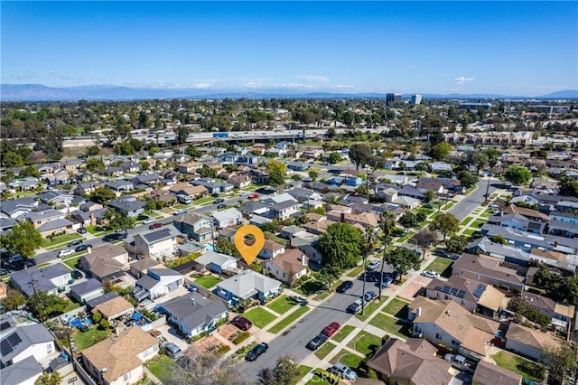 drone / aerial view featuring a residential view and a mountain view