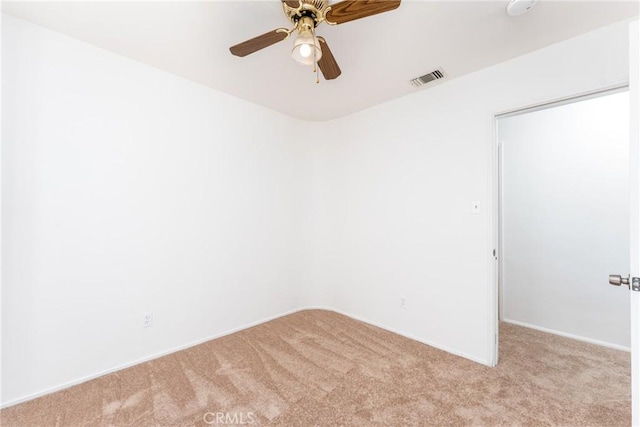 unfurnished room featuring light carpet, visible vents, and a ceiling fan