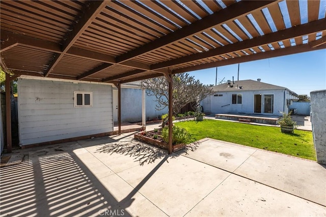 view of patio with a carport, fence, a hot tub, and a pergola