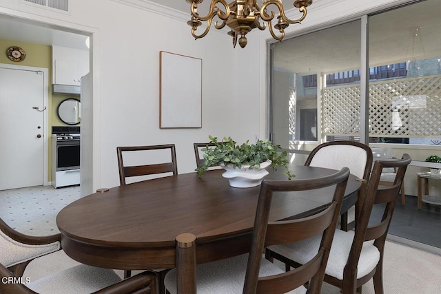 dining area with a chandelier, ornamental molding, and visible vents