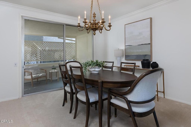 carpeted dining room with a notable chandelier, baseboards, and crown molding