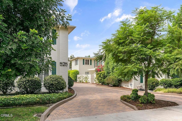 view of front of property with decorative driveway and stucco siding