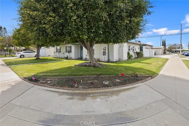 obstructed view of property with a garage, a residential view, concrete driveway, and a front lawn