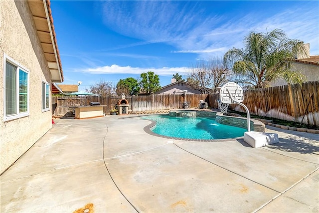 view of pool featuring a patio area, a fenced backyard, and a pool with connected hot tub