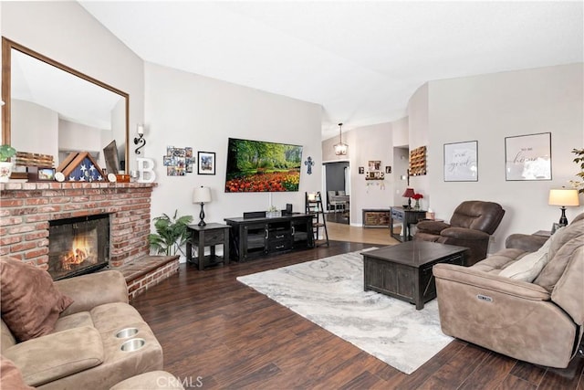 living area with lofted ceiling, a fireplace, and dark wood-type flooring