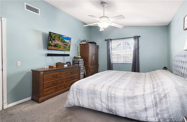 bedroom featuring carpet, visible vents, vaulted ceiling, and a textured ceiling