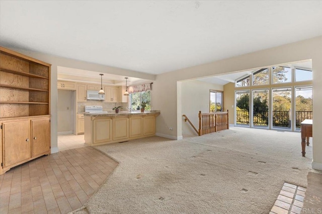 unfurnished living room featuring baseboards, vaulted ceiling, and light colored carpet