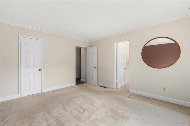 unfurnished bedroom with baseboards, ornamental molding, and carpet flooring