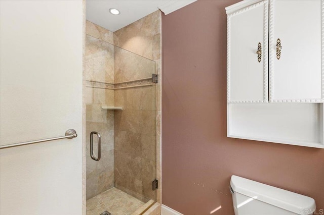 bathroom with toilet, a shower stall, and recessed lighting