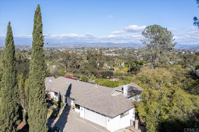 bird's eye view with a wooded view