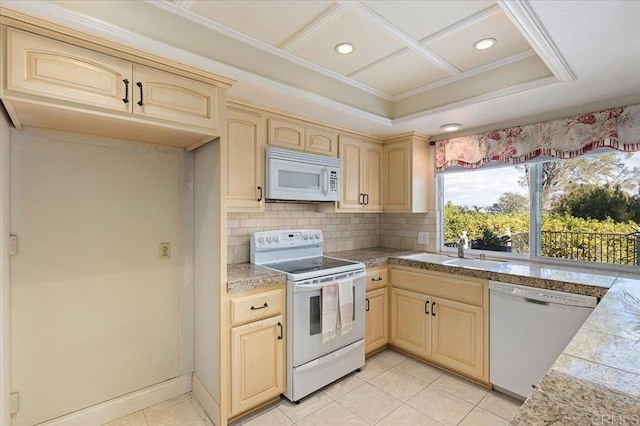 kitchen featuring white appliances, decorative backsplash, tile countertops, light brown cabinets, and a sink