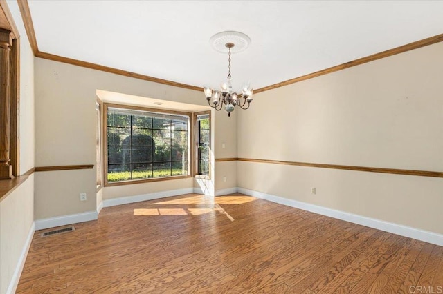 unfurnished dining area featuring ornamental molding, baseboards, and wood finished floors