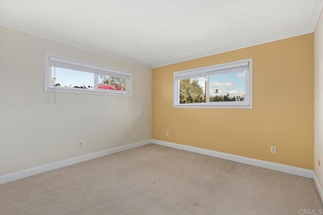 unfurnished room with baseboards, ornamental molding, and light colored carpet