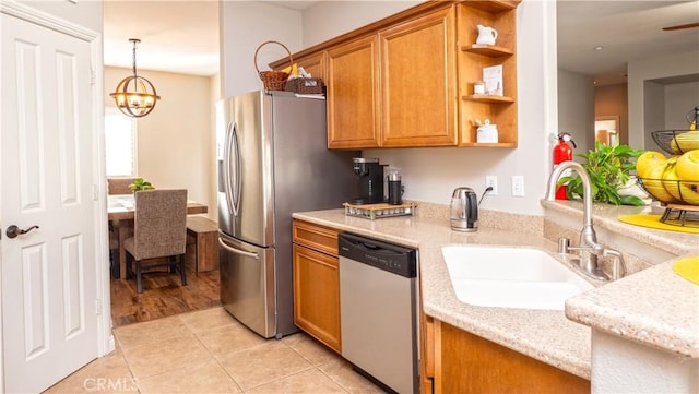 kitchen featuring brown cabinets, light tile patterned floors, open shelves, appliances with stainless steel finishes, and a sink