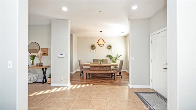 entrance foyer featuring recessed lighting, a notable chandelier, baseboards, and light tile patterned floors