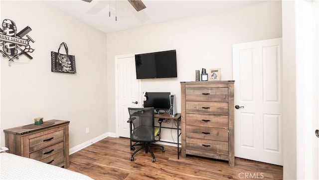 bedroom featuring baseboards and wood finished floors