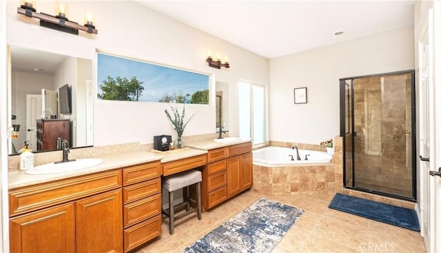 bathroom featuring a stall shower, a garden tub, a sink, and double vanity