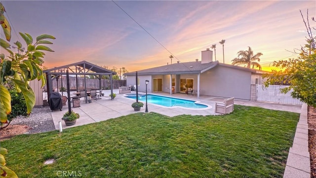 view of pool featuring a fenced backyard, a yard, a gazebo, a fenced in pool, and a patio area