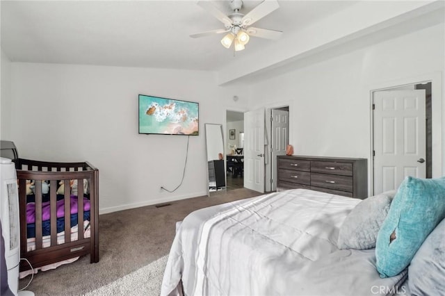 bedroom with carpet floors, vaulted ceiling, baseboards, and ceiling fan