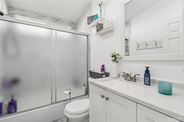 full bathroom with toilet, shower / bath combination with glass door, and vanity