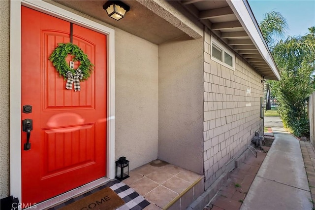 view of exterior entry with stucco siding