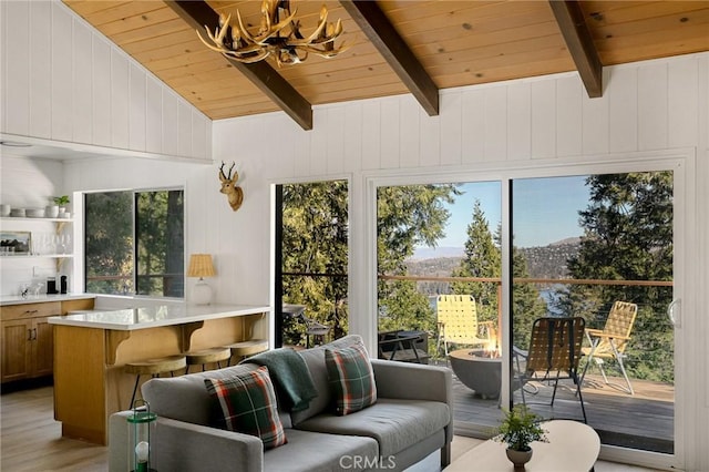 sunroom / solarium featuring a wealth of natural light, wooden ceiling, and vaulted ceiling with beams