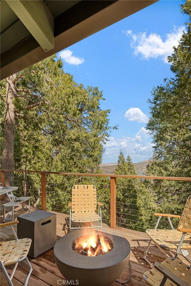 wooden deck with a fire pit