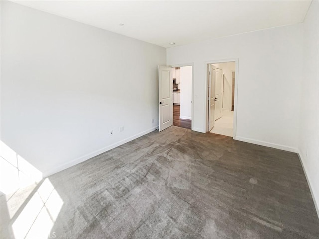 unfurnished bedroom featuring carpet floors and baseboards