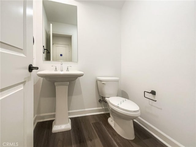 3622 E Delight Paseo Unit 112, Ontario, CA 91761 - half bathroom featuring a sink, baseboards, toilet, and wood finished floors