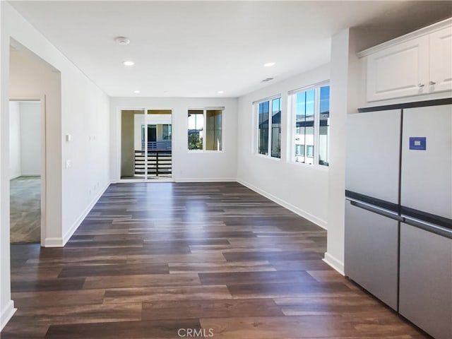 interior space featuring baseboards, dark wood-type flooring, and recessed lighting