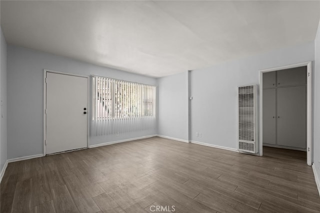 interior space featuring visible vents, baseboards, and wood finished floors