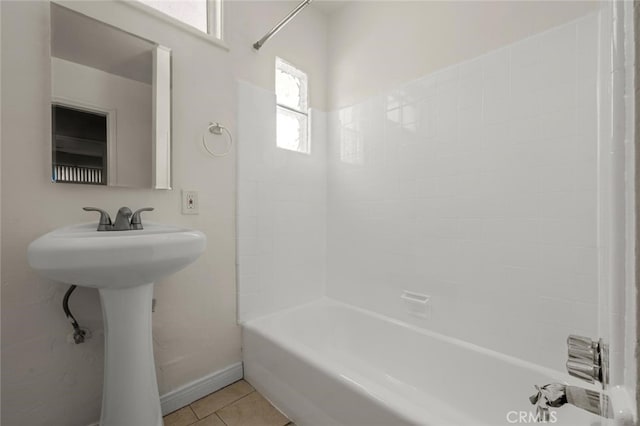 full bath featuring tile patterned flooring, tub / shower combination, and baseboards