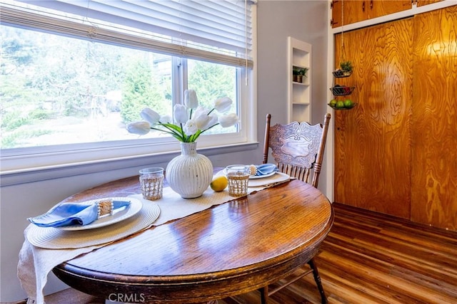 dining space featuring plenty of natural light and wood finished floors