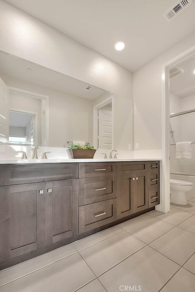 114 Source, Irvine, CA 92618 - full bath featuring tile patterned flooring, toilet, double vanity, and a shower