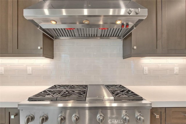 114 Source, Irvine, CA 92618 - kitchen with ventilation hood, light countertops, stove, and decorative backsplash