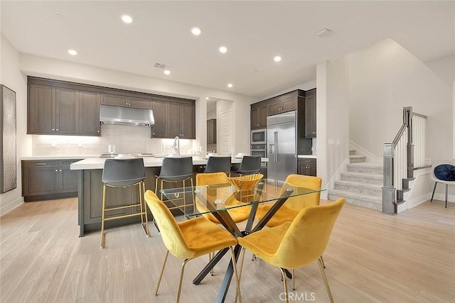 114 Source, Irvine, CA 92618 - dining room featuring baseboards, light wood-style floors, stairs, and recessed lighting