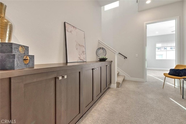 114 Source, Irvine, CA 92618 - corridor with light carpet, stairway, and baseboards