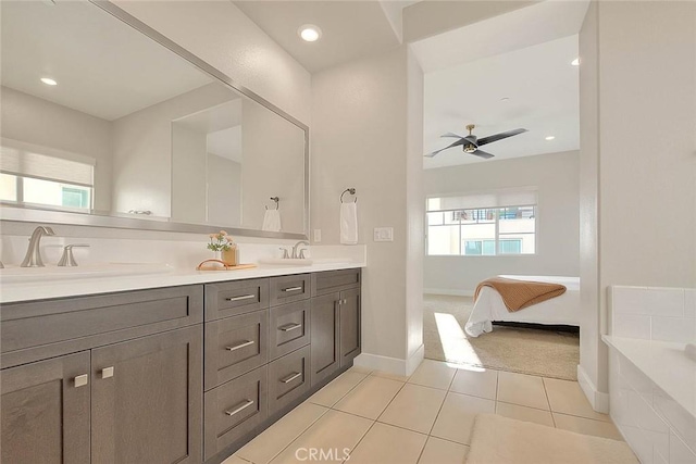 114 Source, Irvine, CA 92618 - ensuite bathroom with ceiling fan, tile patterned floors, double vanity, a tub to relax in, and baseboards