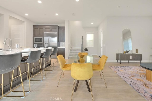 114 Source, Irvine, CA 92618 - dining area with light wood finished floors, recessed lighting, and stairway