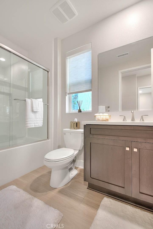 114 Source, Irvine, CA 92618 - bathroom with vanity, combined bath / shower with glass door, and wood finished floors