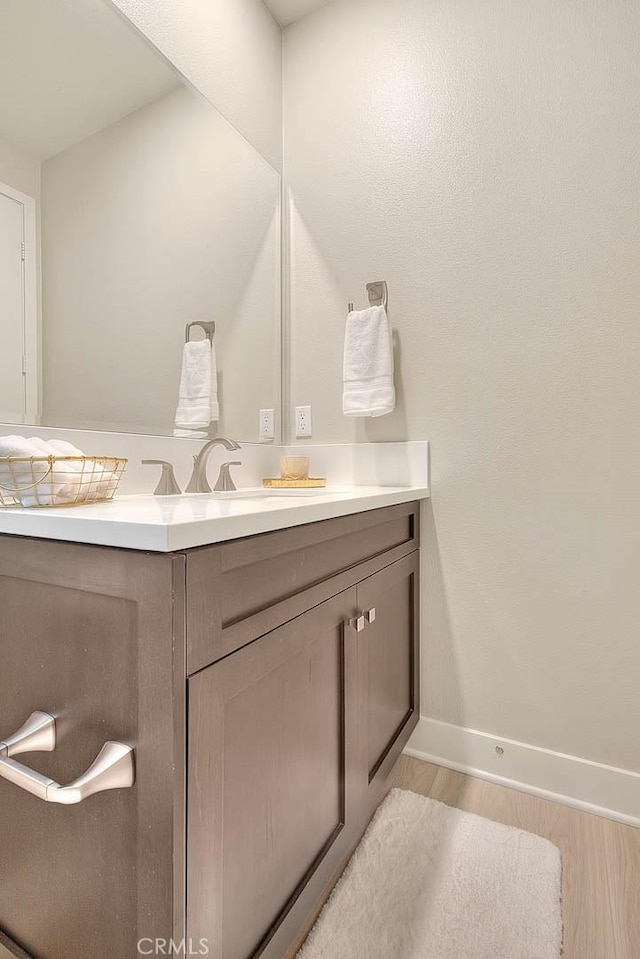 114 Source, Irvine, CA 92618 - bathroom with wood finished floors, baseboards, and vanity