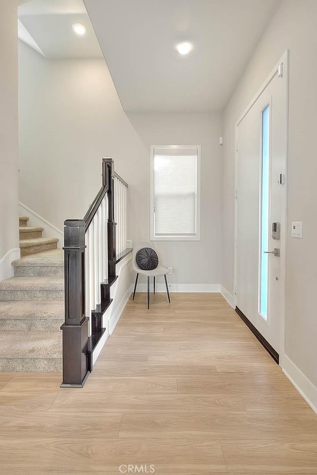 114 Source, Irvine, CA 92618 - foyer with stairway, light wood-style floors, and baseboards