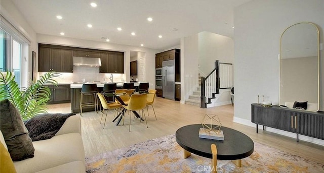 114 Source, Irvine, CA 92618 - dining space featuring light wood-style flooring, stairway, and recessed lighting