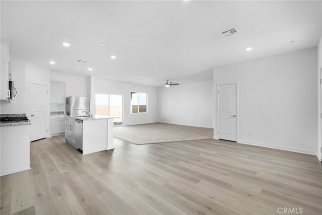 unfurnished living room with recessed lighting, visible vents, ceiling fan, and light wood finished floors