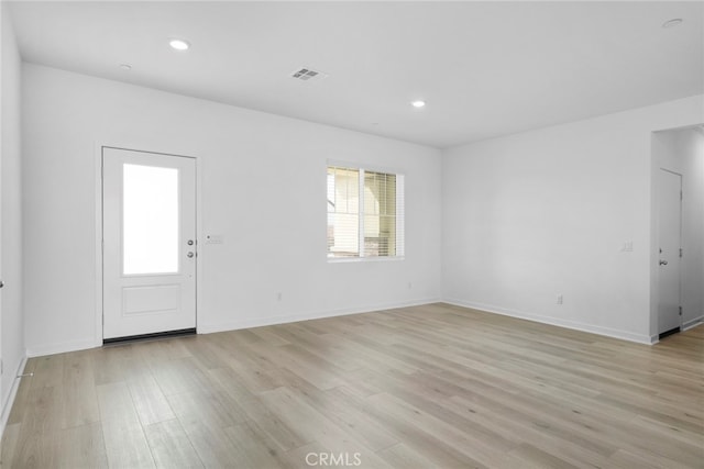 foyer entrance with light wood-type flooring, visible vents, baseboards, and recessed lighting