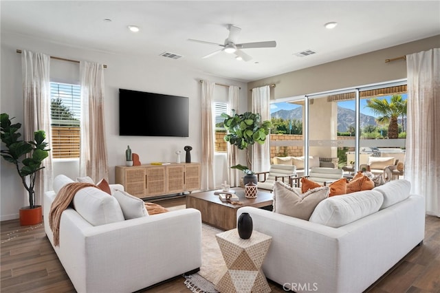 living area with ceiling fan, wood finished floors, visible vents, and recessed lighting